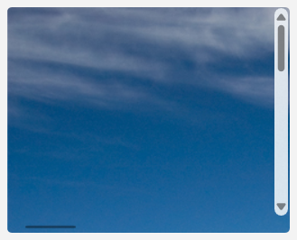 Una imagen de una montaña acercada hasta ahora que solo el cielo azul y las nubes en la parte superior izquierda de la imagen son visibles.